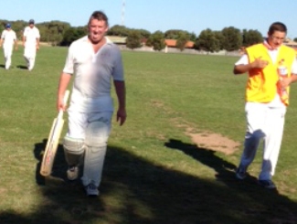 Steven Ball walks off after his unbeaten century against Taylors Lakes, accompanied by Moonee Valley's square leg umpire, Nick Brelis.